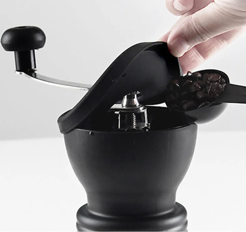 Hand grinder coffee machine with beech wood body and black finish on a countertop, width 88mm