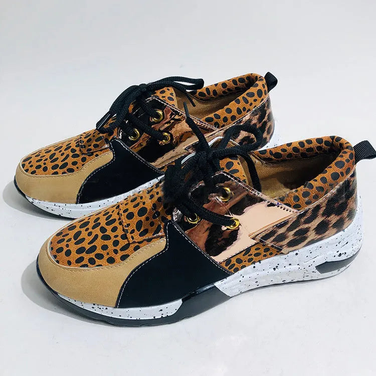 Women's black suede casual sneakers with a wedge heel and round toe on a white background.