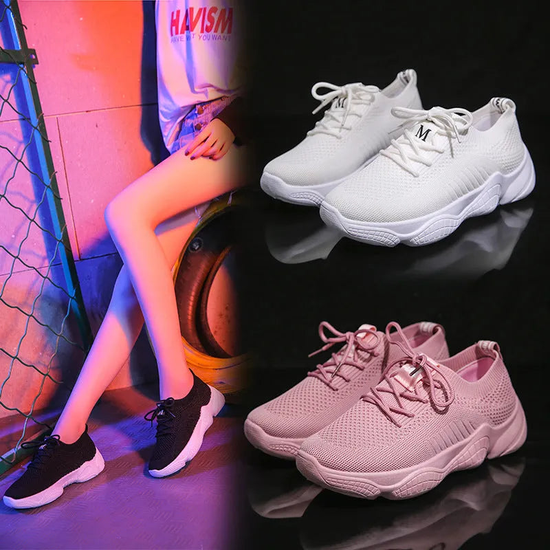 Women's white woven sports shoes with thick rubber sole and front strap.