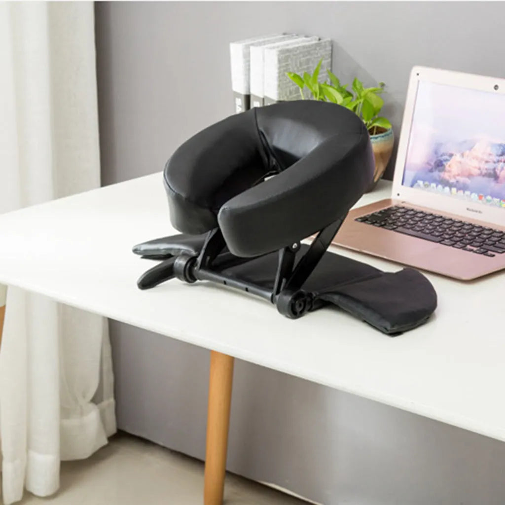 U-shaped SPA health pillow with PU leather cover on a massage table, black colour, showing adjustable height cradle