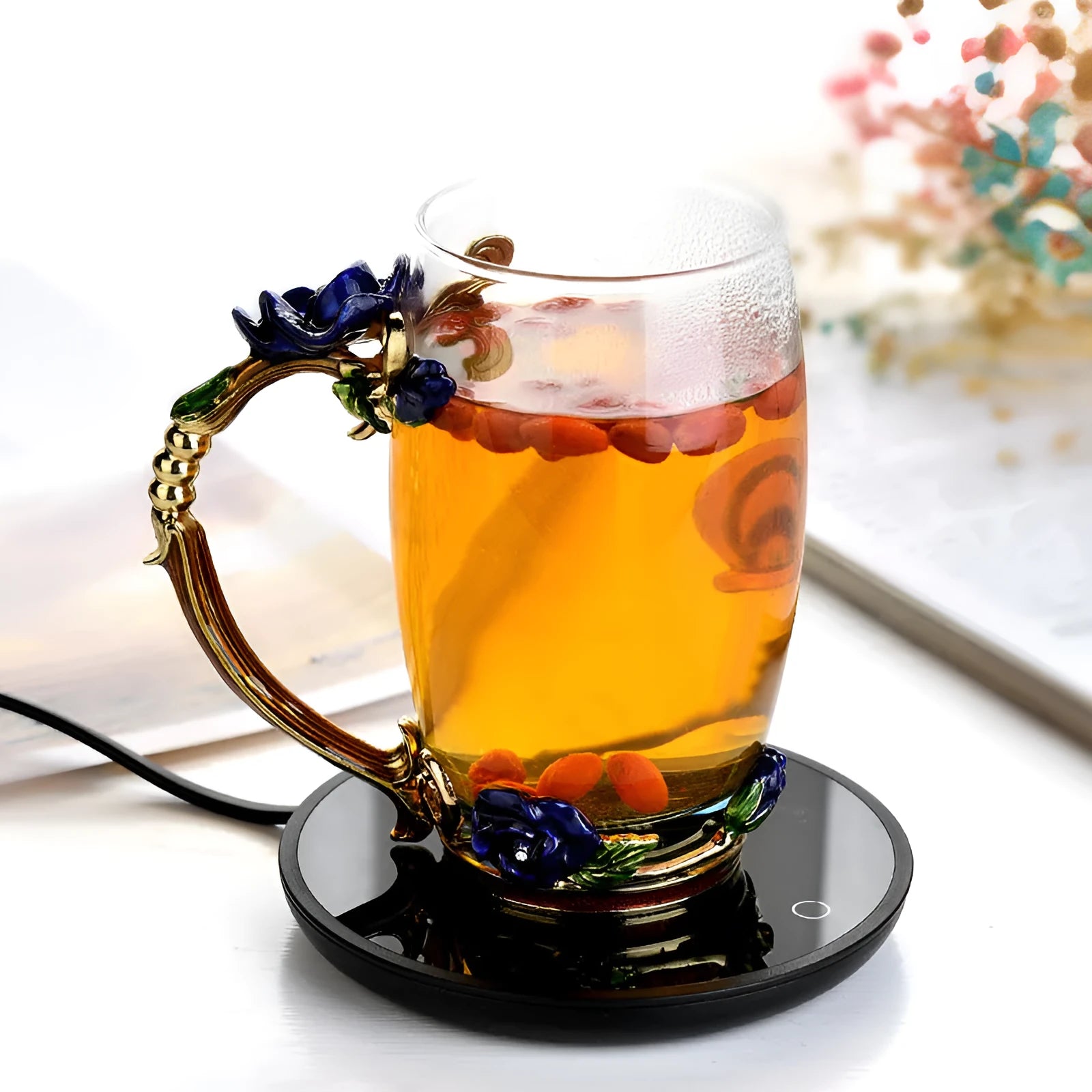 Black circular cup warmer with temperature control buttons on side