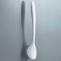 Silicone bathroom cleaning brush with ergonomic curved handle and soft rubber head in black