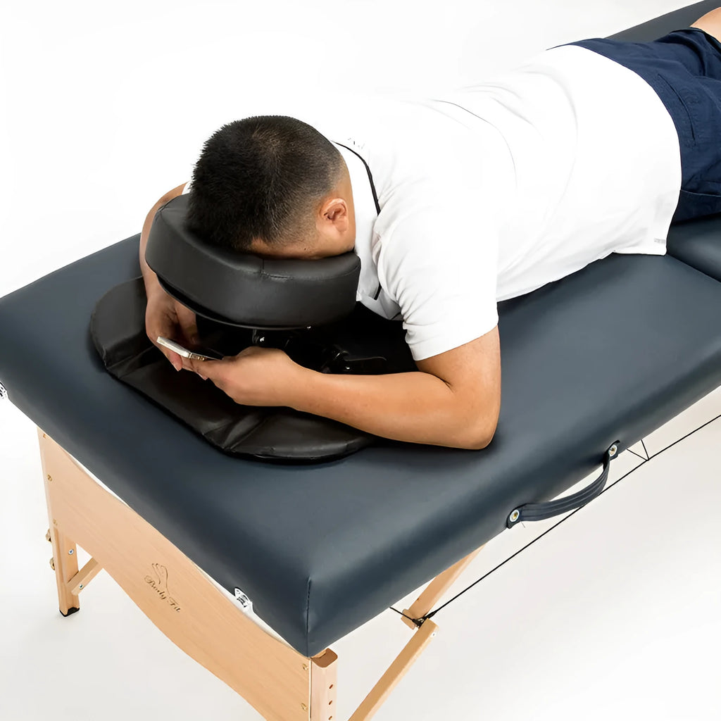 U-shaped SPA health pillow with PU leather cover on a massage table, black colour, showing adjustable height cradle