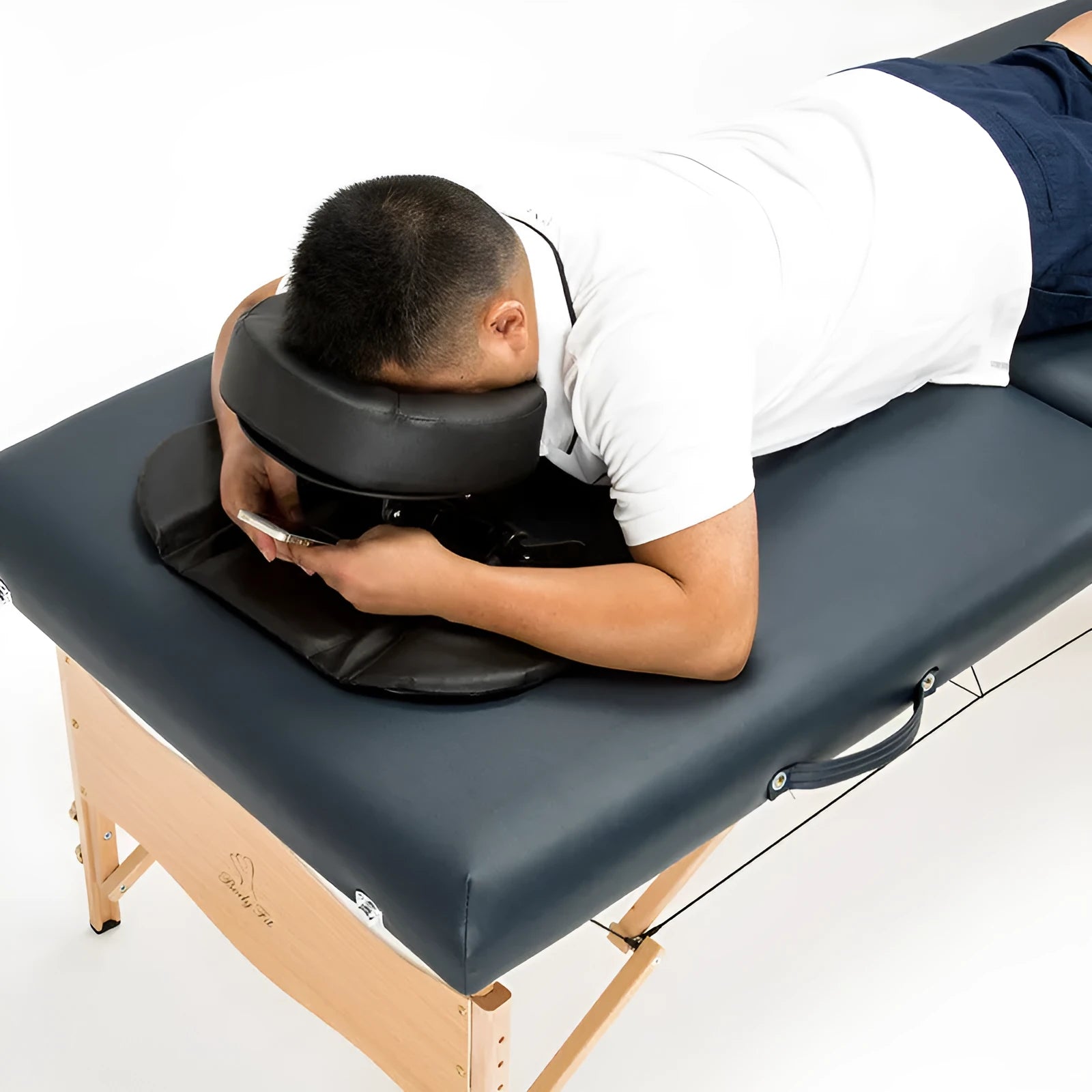U-shaped SPA health pillow with PU leather cover on a massage table, black colour, showing adjustable height cradle