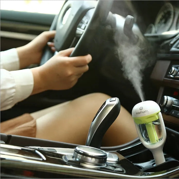 Portable car humidifier with rotating nozzle in blue, green, pink, or purple colours