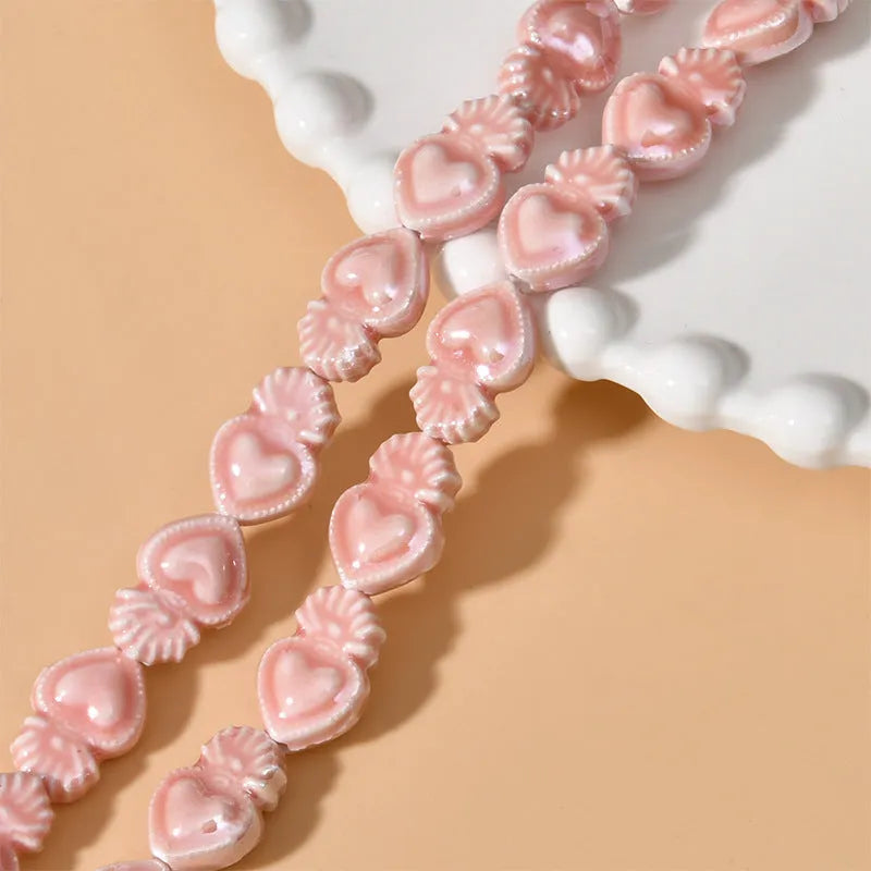 Assorted small ceramic torch beads in multiple colours on a white background.