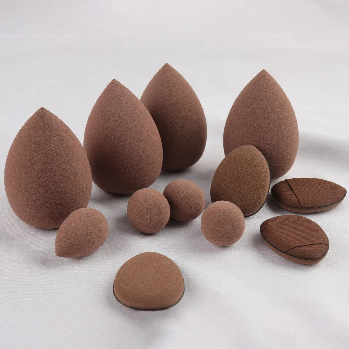40-piece makeup sponge set in coffee brown, pink, and purple on white background