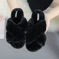 Women's black cross open-toe fur slippers showing patterned non-slip sole and soft interior