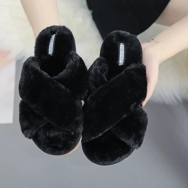 Women's black cross open-toe fur slippers showing patterned non-slip sole and soft interior