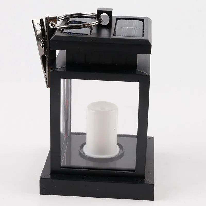 Solar LED candle light with black plastic shade, monocrystalline silicon panel, and IP44 waterproof rating for outdoor garden use