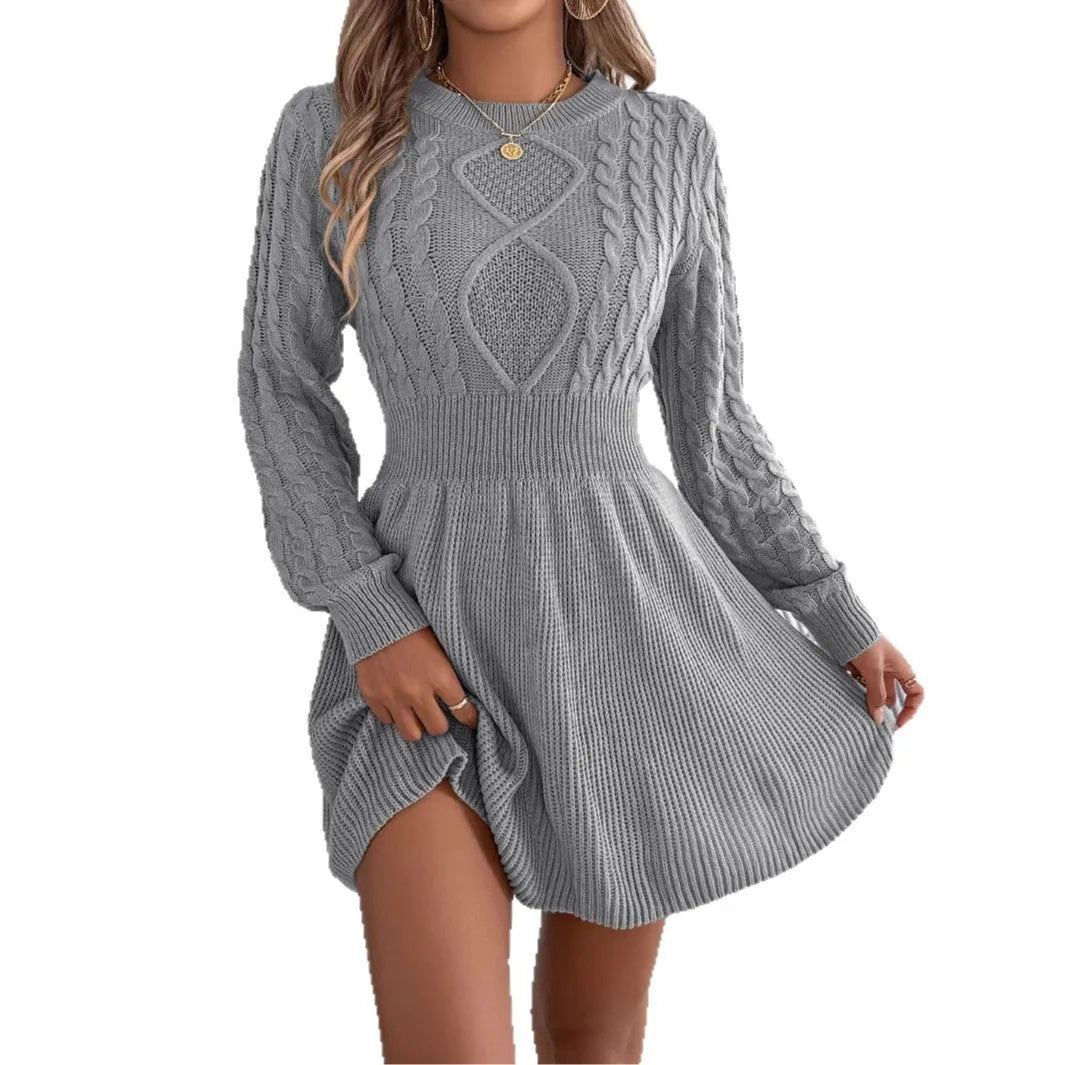 A woman wearing a wine red lantern sleeve sweater dress with an elastic waist.