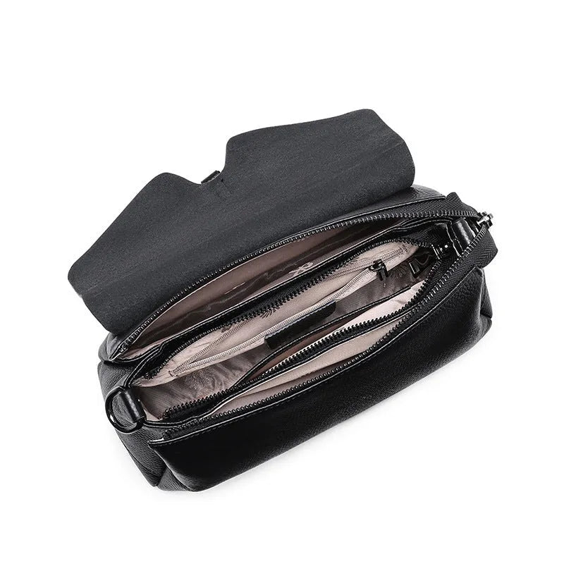Women's soft cowhide shoulder bag in Wine Red with three main pockets and adjustable strap on white background