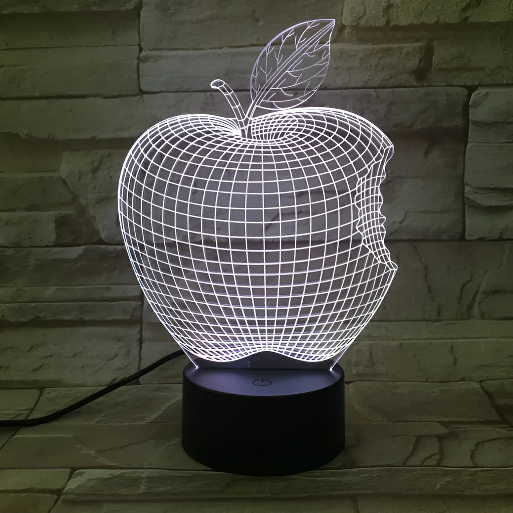 3D fruit-shaped colourful LED night light with touch control on a table.