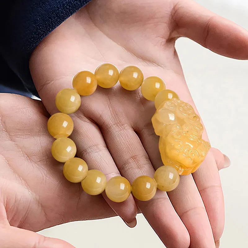 Hand-carved Jinsi Jade money bracelet showing golden thread patterns with jade beads