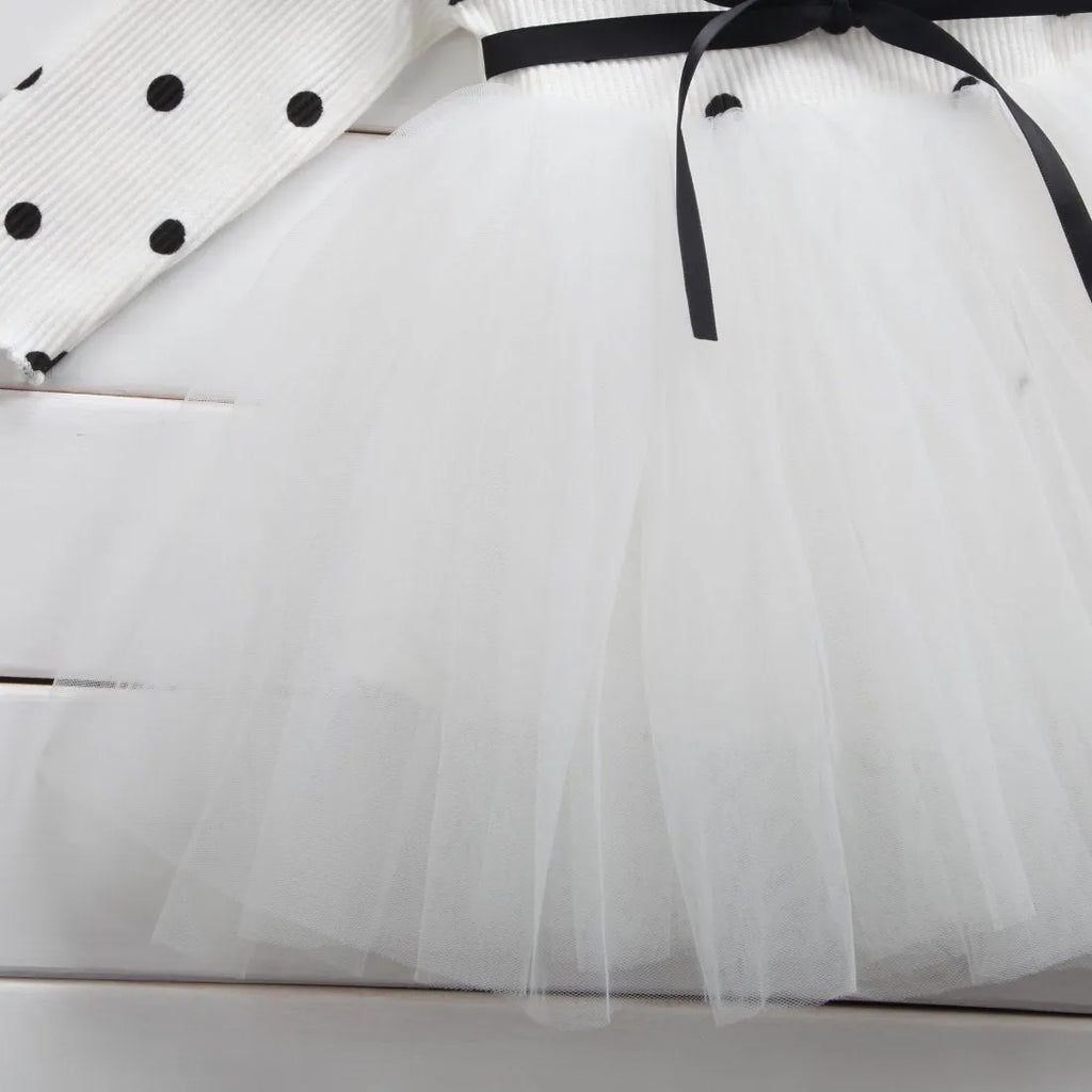 A baby girl's long sleeve black tutu dress with lace detail, suitable for birthdays and christenings.