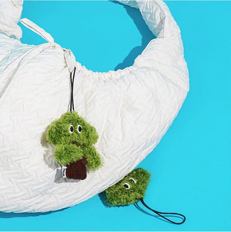 Green pine tree shaped fabric cat toy bag with hanging loop.