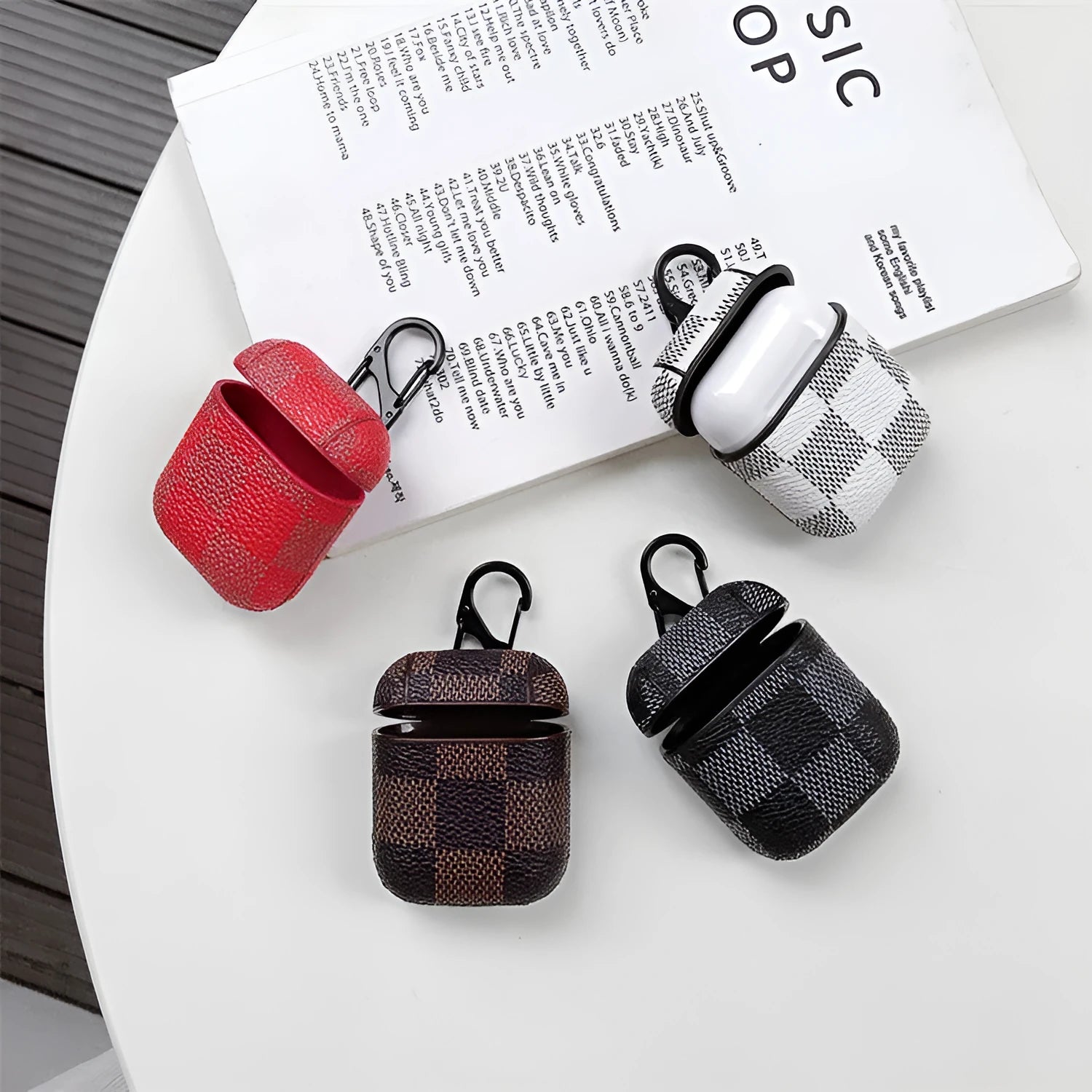 Black lattice hard shell case for iPhone XS Max and AirPods with anti-lost hook attached.