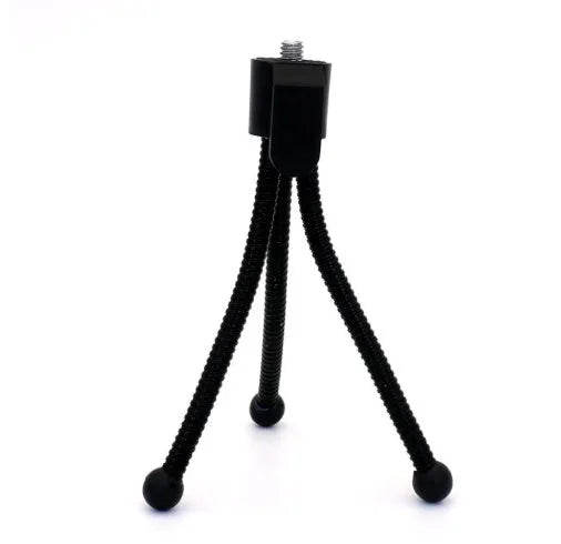 Small aluminium folding tripod with ball head mounted with smartphone on desktop