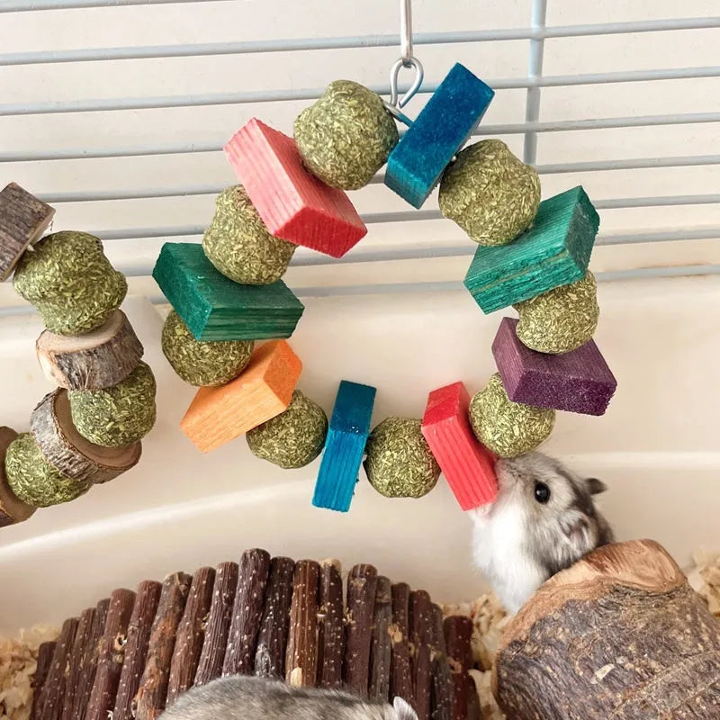 Hamster chew toy with applewood chewing surface and decorative straw ball ring