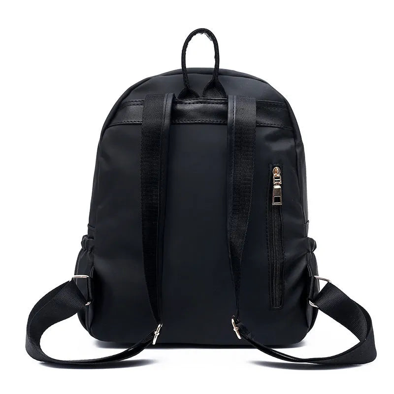 Black waterproof Oxford backpack for women, 34cm high, showing front view on plain background