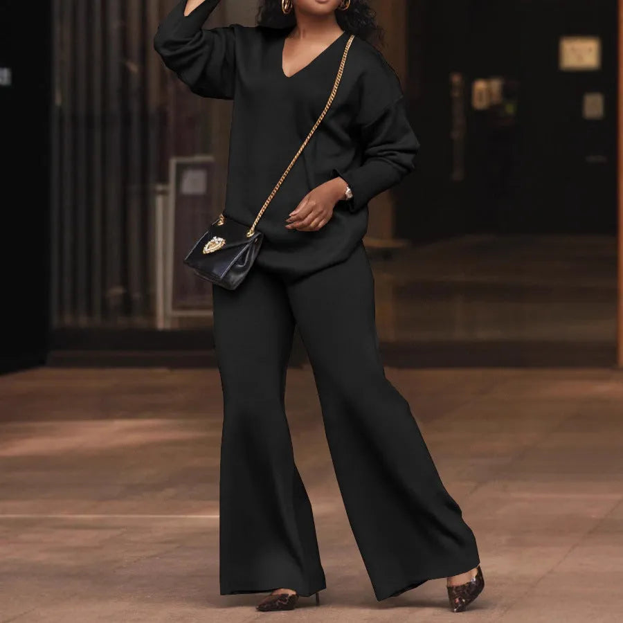Women's brown suede two-piece casual suit with long sleeves and trousers on a hanger