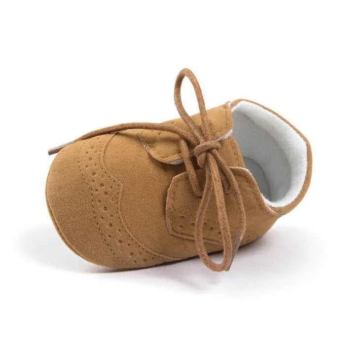 Vintage style soft-soled baby walking shoes for boys in black, grey, light brown, and white.
