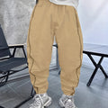 Man wearing blue cropped bamboo fibre sports trousers with a loose, elasticated fit.