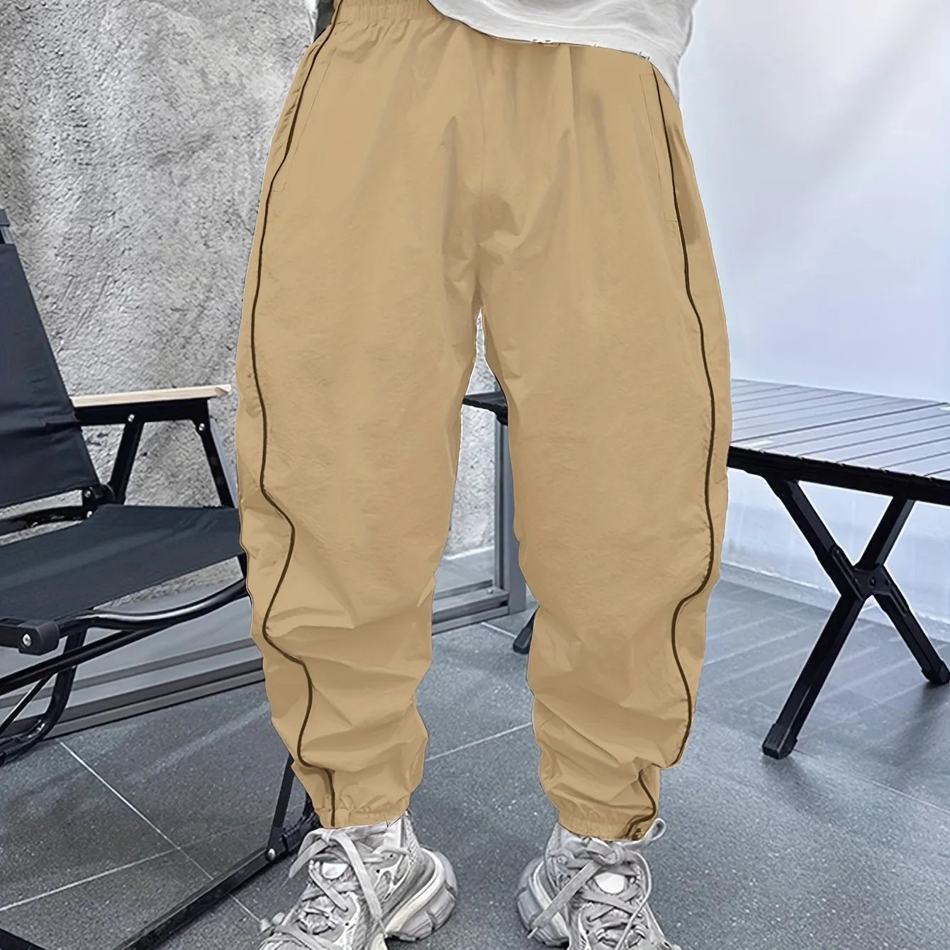 Man wearing blue cropped bamboo fibre sports trousers with a loose, elasticated fit.