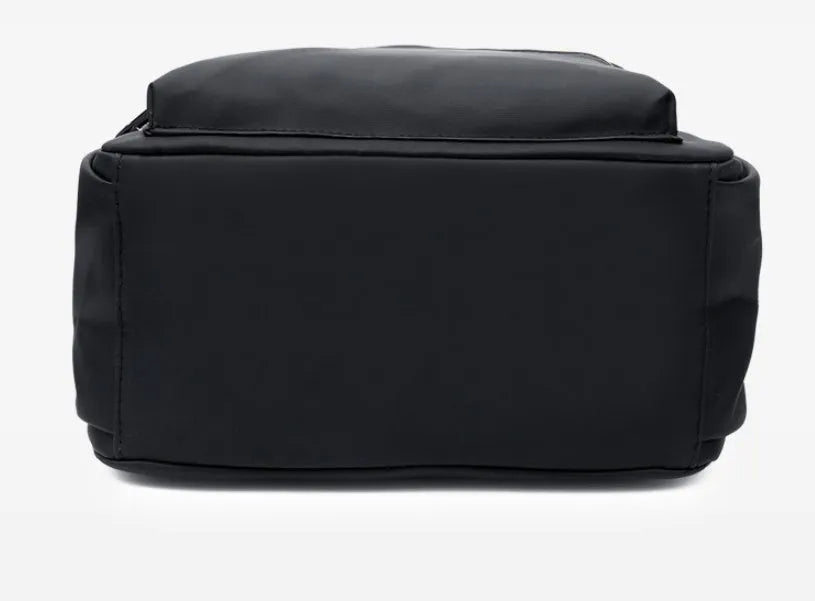 Black waterproof Oxford backpack for women, 34cm high, showing front view on plain background
