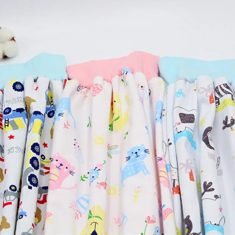 Baby girl wearing a multi-colour waterproof cotton diaper skirt with elastic waistband for belly protection