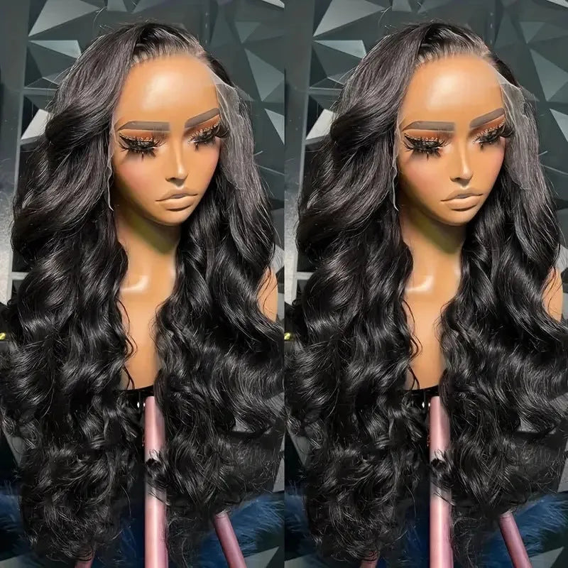 A woman modelling a black synthetic wig with medium-long curly waves and a natural hairline.