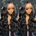 A woman modelling a black synthetic wig with medium-long curly waves and a natural hairline.