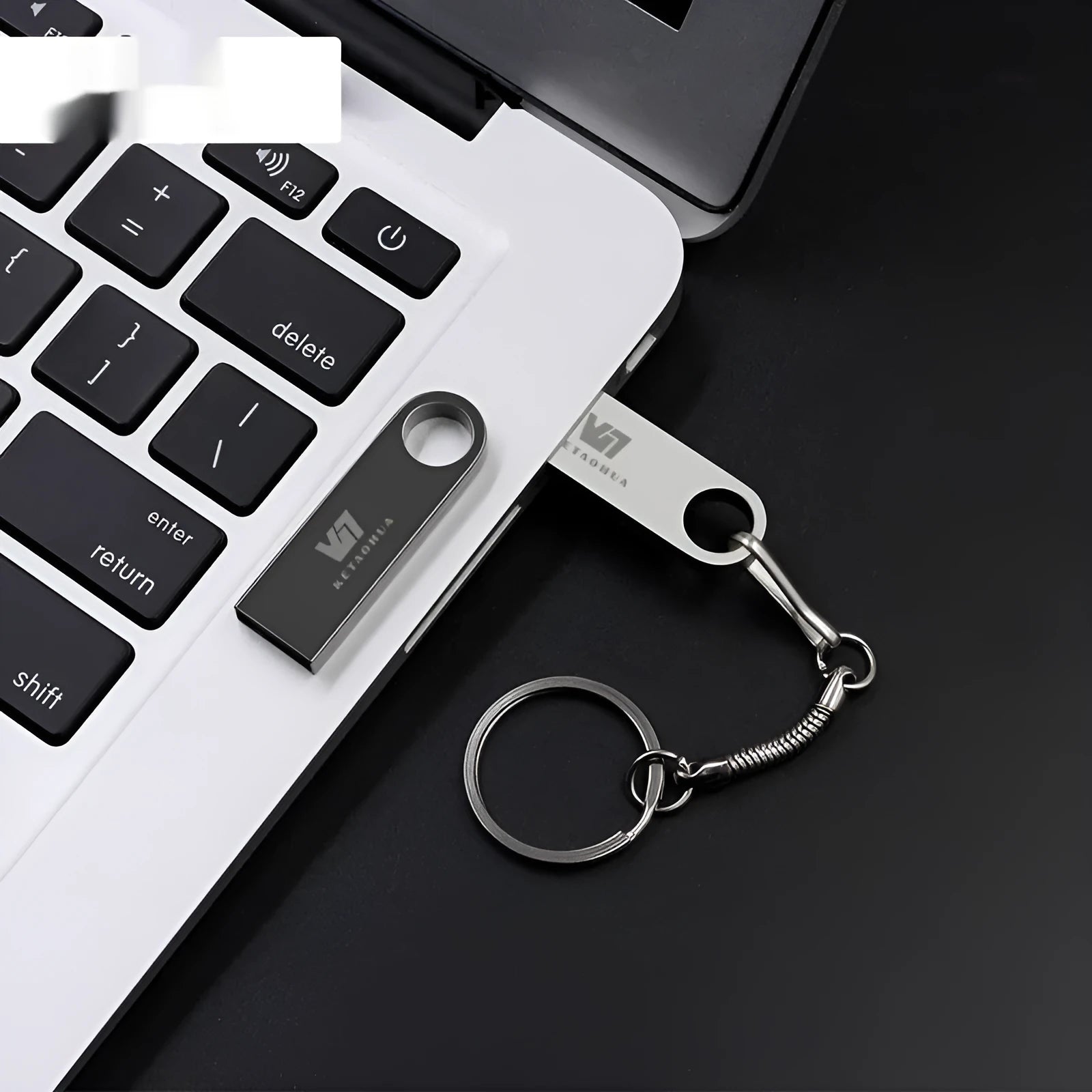 Silver metal car-shaped USB flash drive on a white background