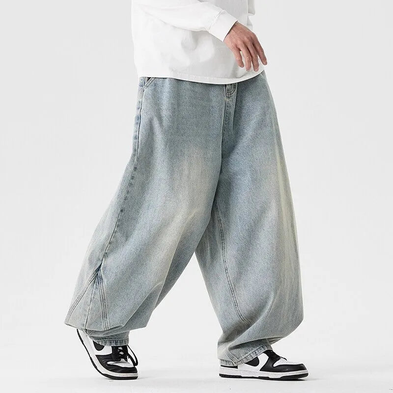 Men's plus size baggy jeans in light blue denim with wide straight legs and a low waist.