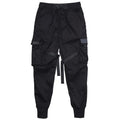 Black cotton overalls with tapered leg and small foot opening on plain background
