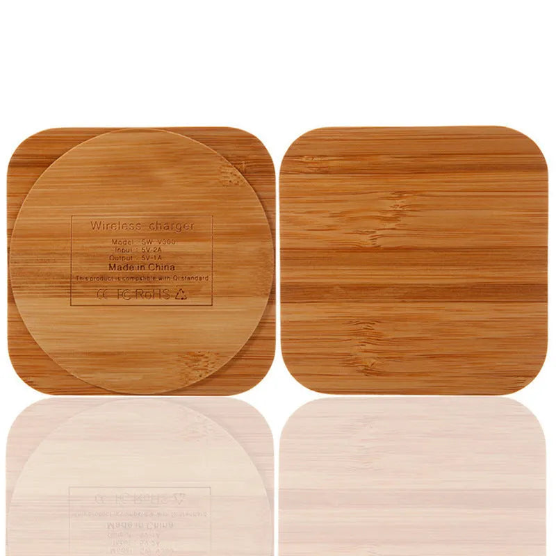 Square wooden bamboo 5W QI wireless charging pad for smartphones on a desk.