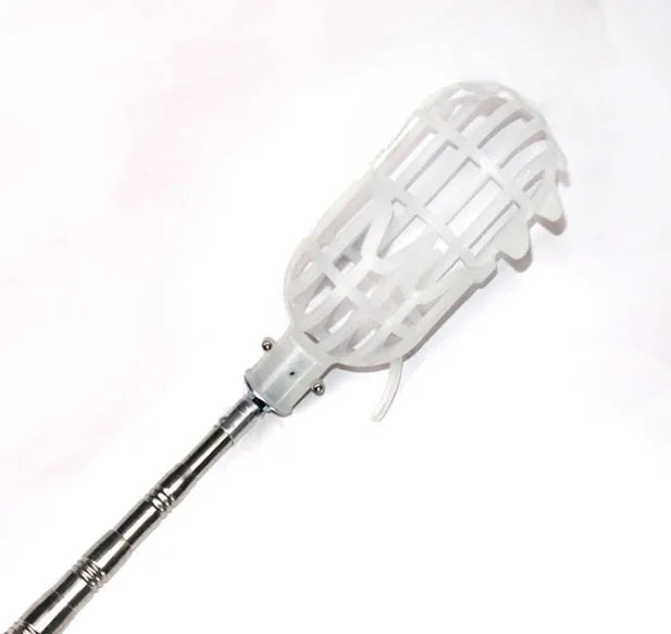 Metal fruit picker with silver ring and cotton bag for picking apples and pears in a garden