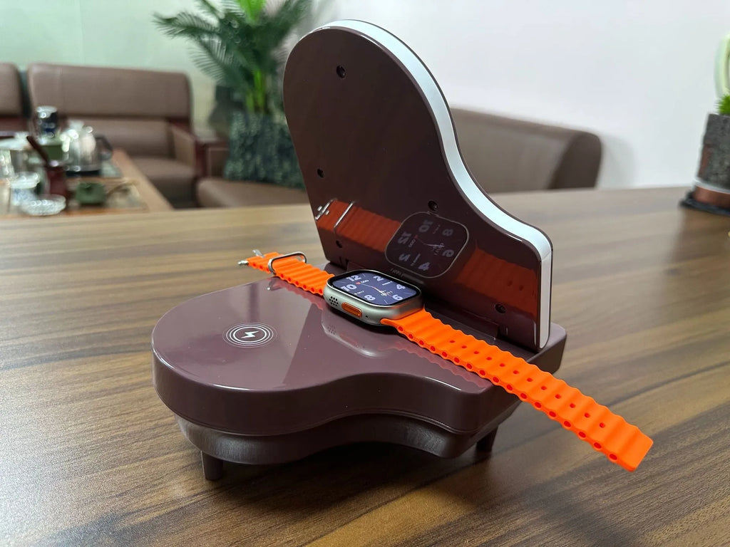 Black multi-function Bluetooth speaker with wireless charger and phone holder on a desk