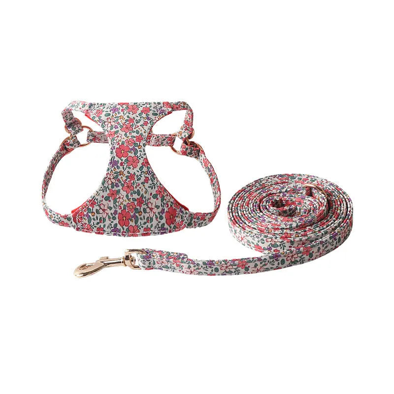 Cloth dog harness and leash set shown in various colours including a floral print, for small dogs.