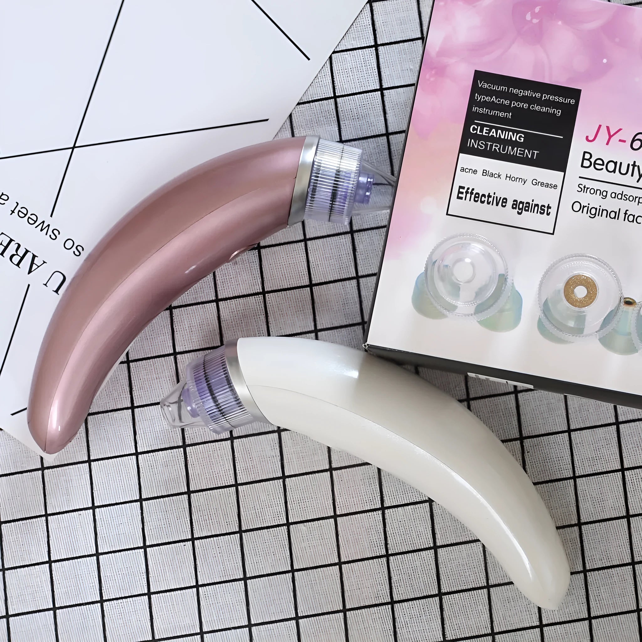 JY-666 electric blackhead suction instrument in rose gold and white colours for facial pore cleansing