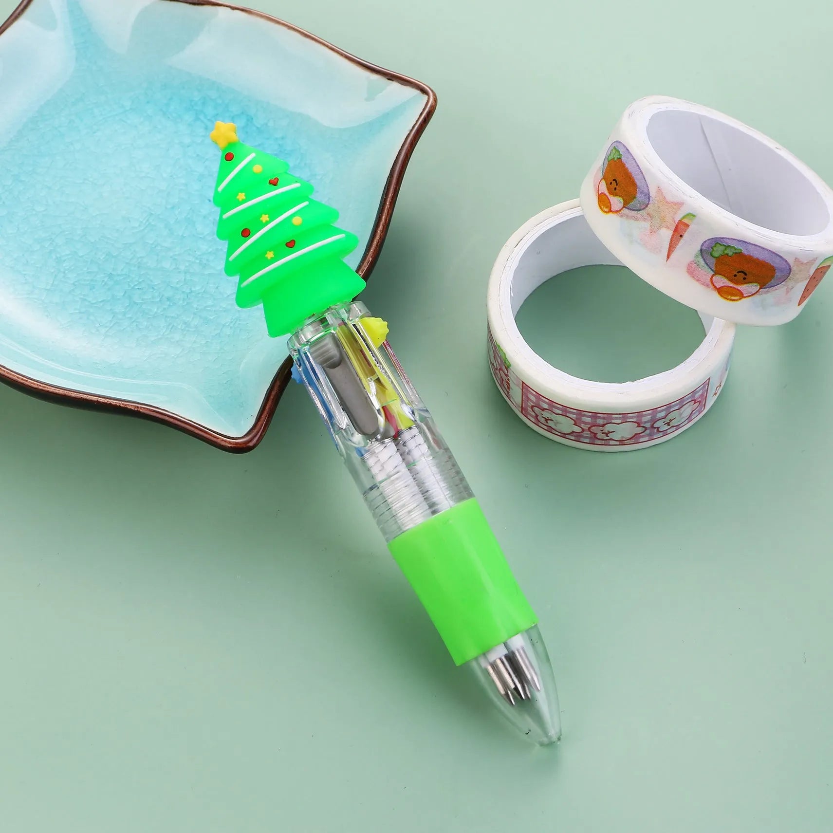 11cm long Christmas-themed four-colour ballpoint pen showing festive designs like reindeer and trees.