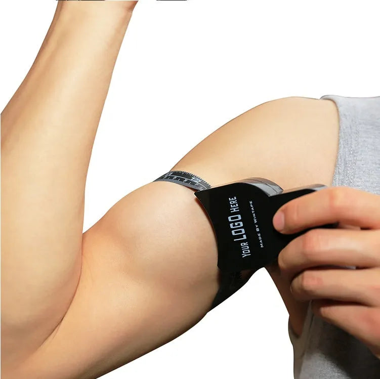 Black ABS plastic body fat caliper with measurement scale and cable.