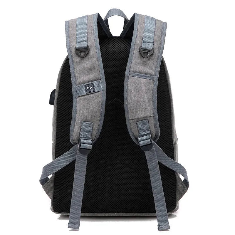 Canvas backpack with USB charging port and multiple pockets including a laptop compartment
