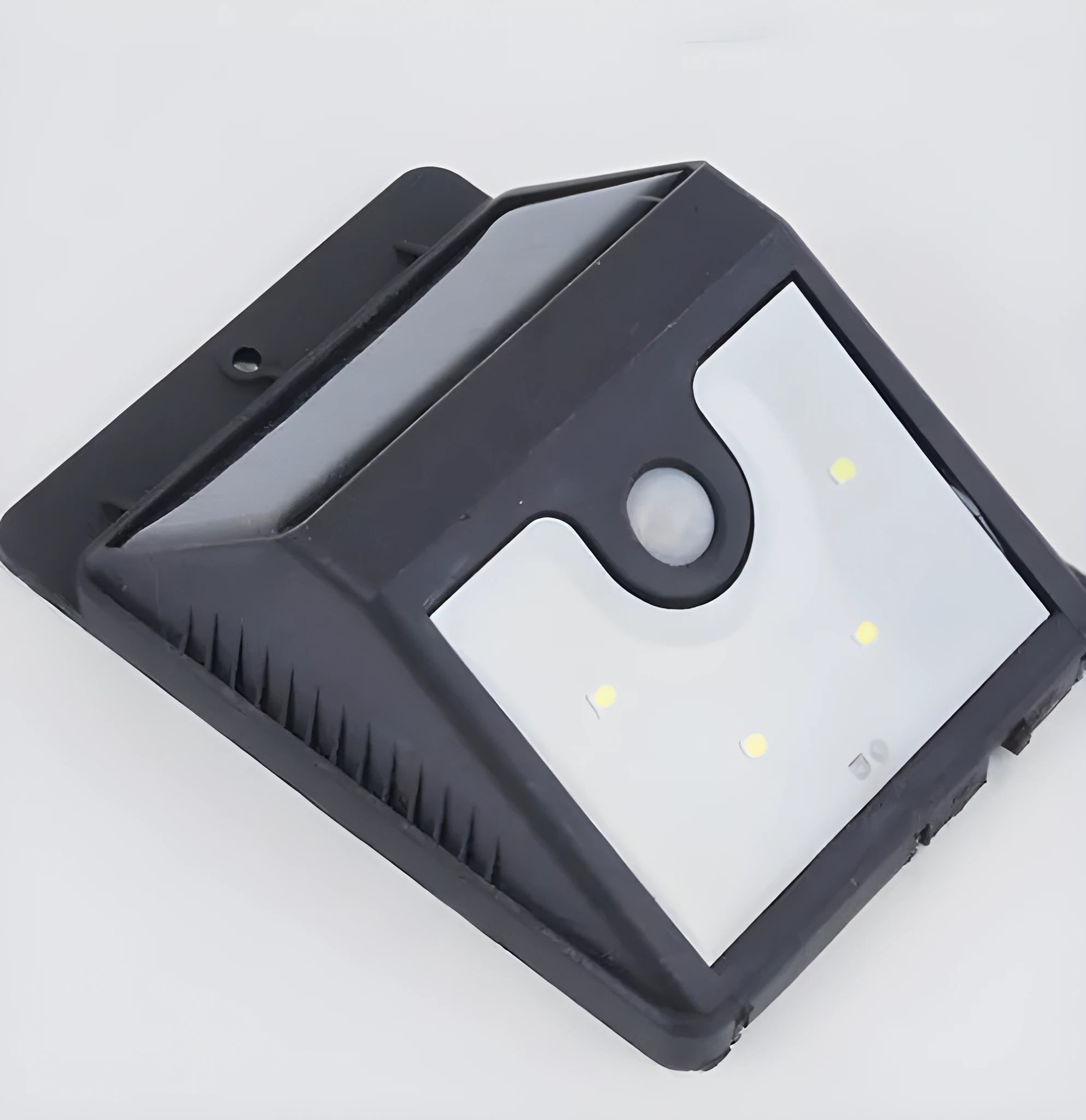 Outdoor solar powered light with 4 LEDs and motion sensor mounted on a garden wall