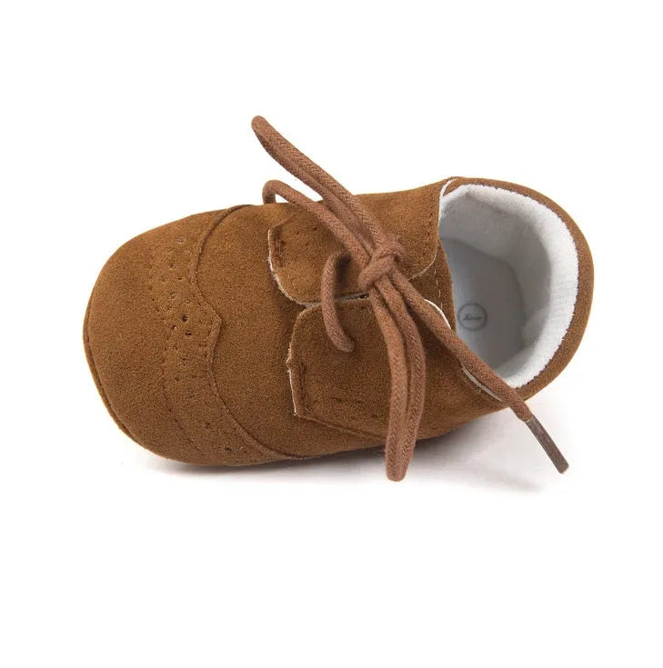 Vintage style soft-soled baby walking shoes for boys in black, grey, light brown, and white.