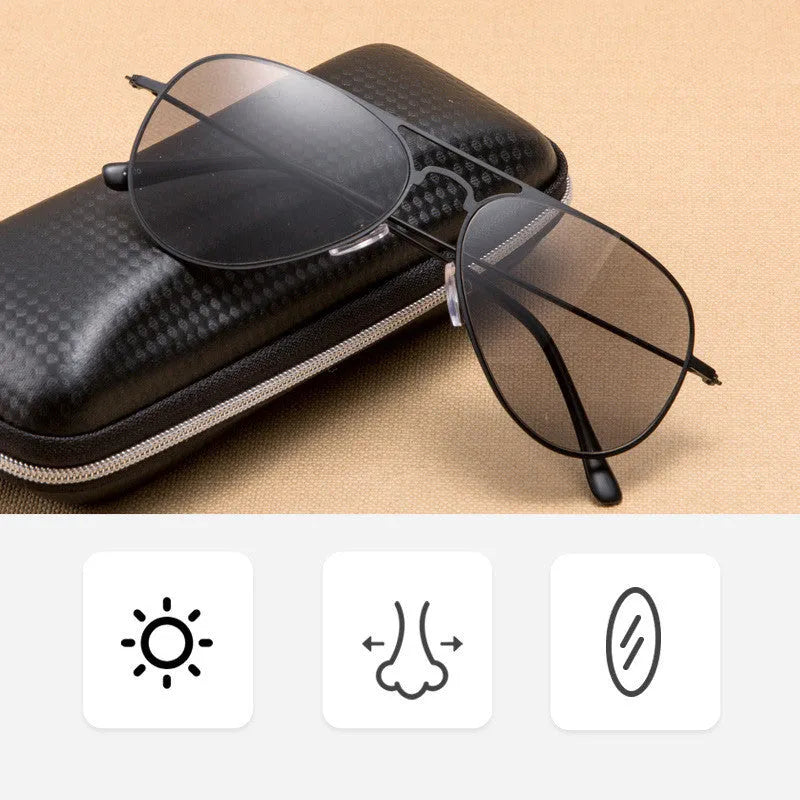 Full lens sun reading glasses with black stainless steel frame resting on a table