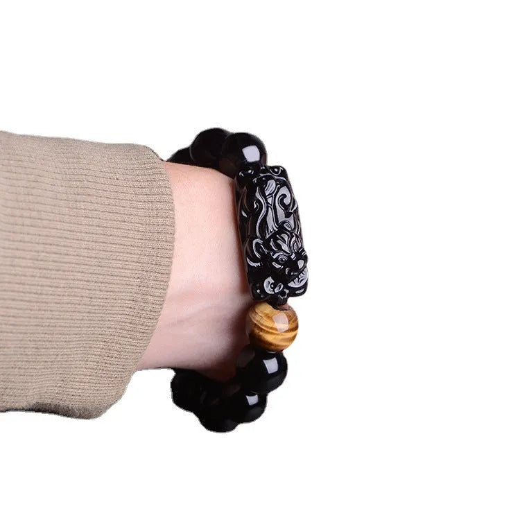 Natural obsidian carved Pi Xiu bracelet with black beads on a cord, gift box and bag visible