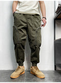 Men's loose-fit cotton cargo trousers with elastic waist, zipper, and multiple big pockets in army green