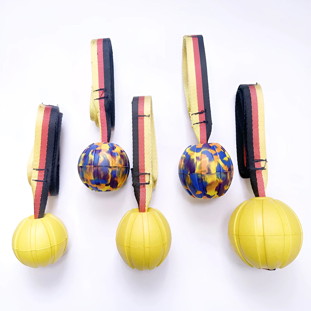 Yellow and camouflage coloured EVA floating dog balls with strings in 6.5cm, 7cm, and 9cm sizes.