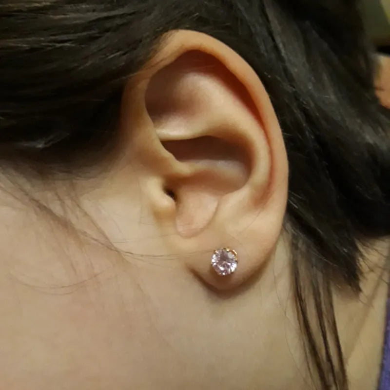Disposable ear piercing gun with built-in crown stud in 316L stainless steel with zirconium inlay